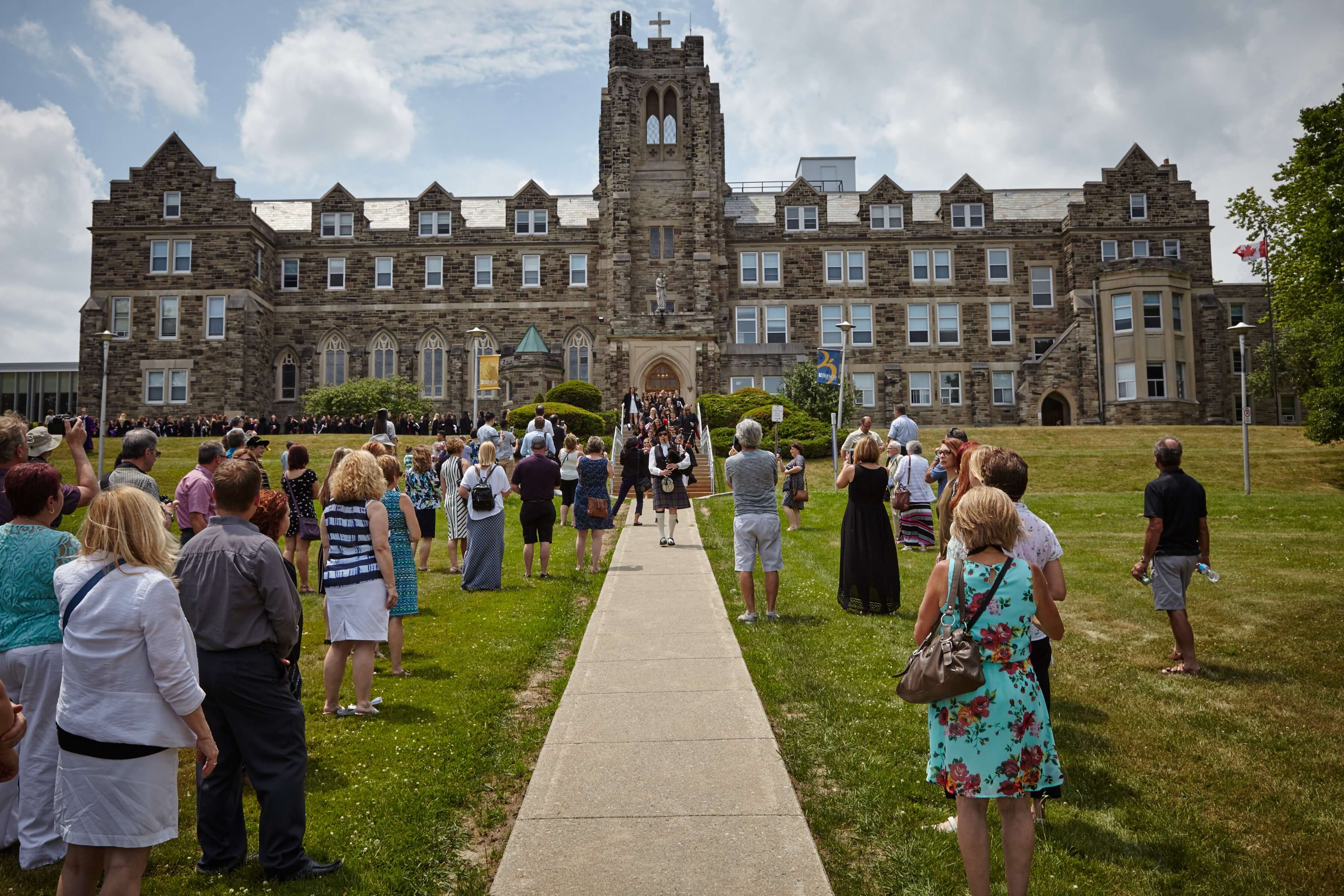 crowd in front of brescia university college building