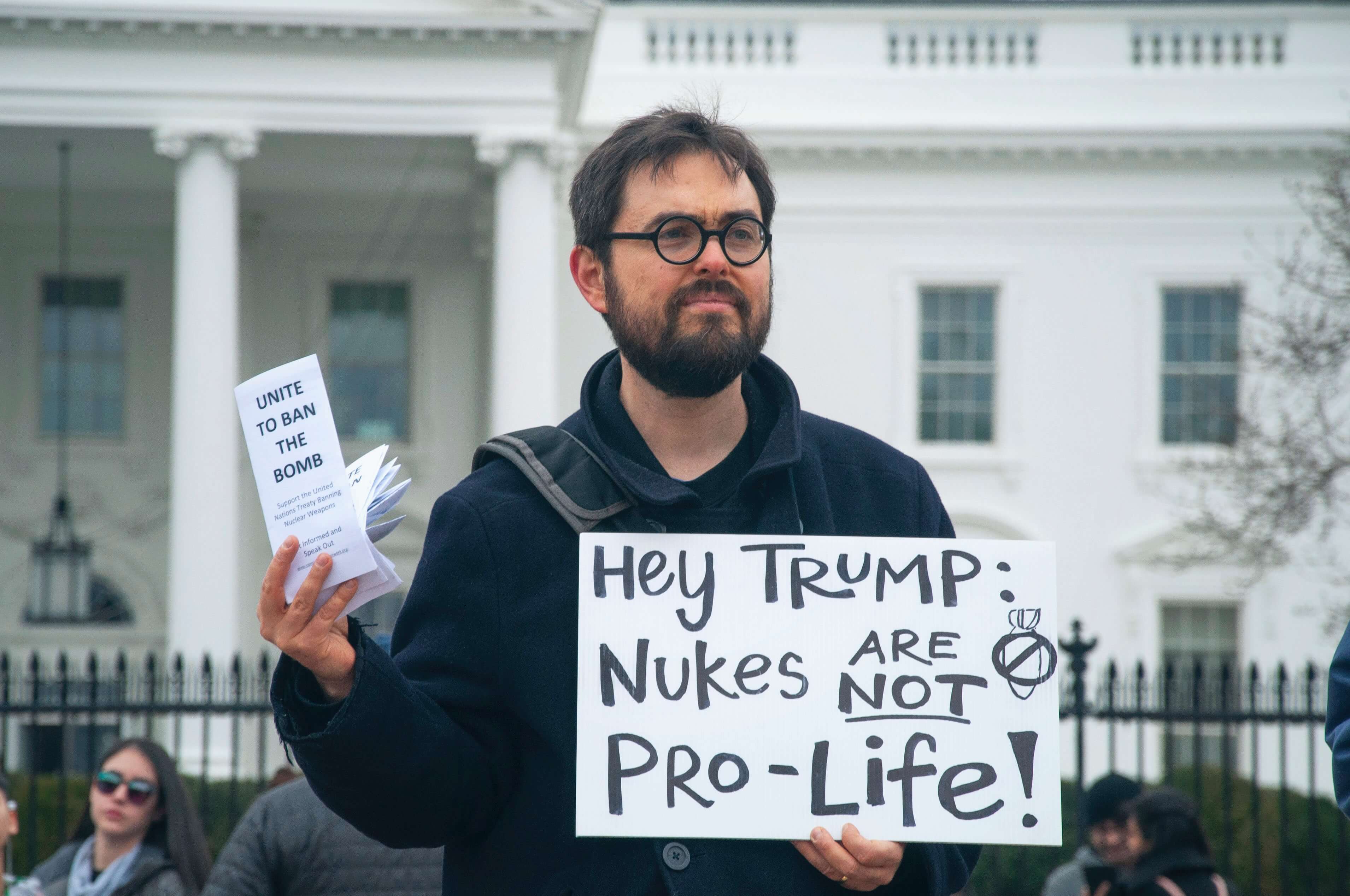 protestor with sign to ban bomb